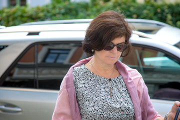 Woman next to car on the street