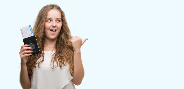 Young blonde woman holding passport of canada and boarding pass pointing and showing with thumb up to the side with happy face smiling
