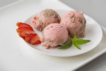 Chocolate and strawberry ice cream, with berries, sprinkled with chocolate