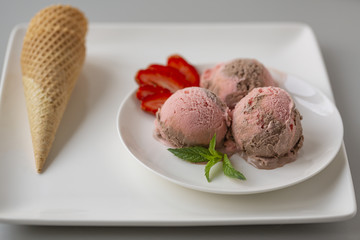 Chocolate and strawberry ice cream, with berries, sprinkled with chocolate