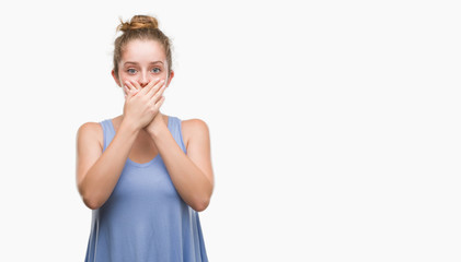 Young blonde woman shocked covering mouth with hands for mistake. Secret concept.