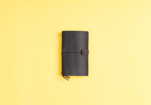 leather journal on yellow background