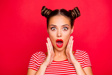 Say what? Close up portrait of  shocked brunette girl with wide open mouth and big eyes hold palms near face isolated on red vivid background