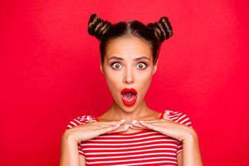 Total sale! Close up portrait of excited and surprised young brunette girl who opened wide her mouth and eyes isolated on red background