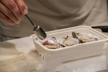 the chef prepares oysters