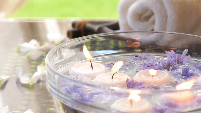Cinemagraph - Burning candles in water. Composition of spa. Motion Photo.