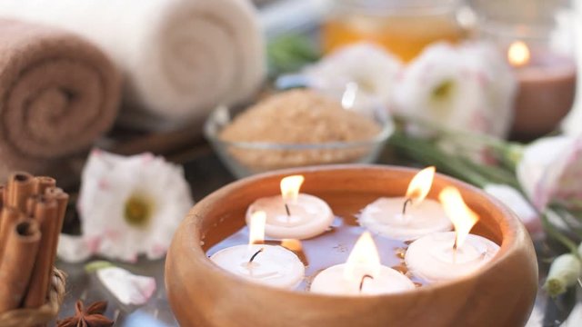 Cinemagraph - Burning candles in water. Composition of spa. Close-up. Motion Photo.