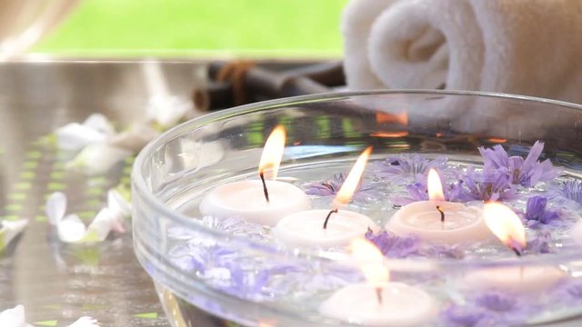 Cinemagraph - Burning candles in water. Composition of spa. Motion Photo.