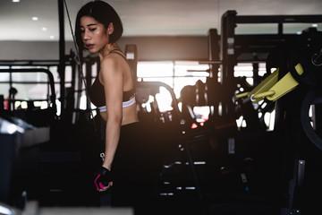 Fototapeta na wymiar young fitness woman execute exercise with exercise-machine in gym