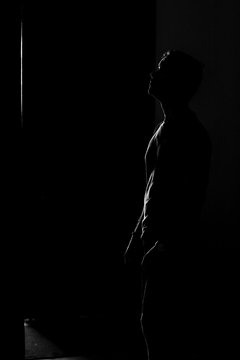 Iluminated man silhouette on black background