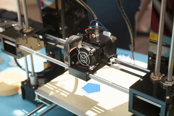 3d printer creating a new plastic object close-up. 3 dimensional printing process on innovative electronic equipment