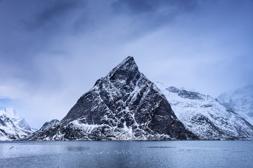 High rocks in the Lofoten islands bay. Natural seascape in the Norway