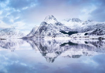 Mountain ridge and reflection at the water. Beautiful natural landscape in the Norway