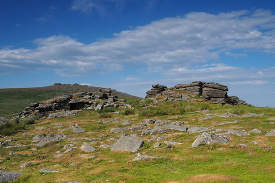 View from Rowtor with West Mill Tor in the background with white clouds in a blue sky, Dartmoor National Park, Devon, UK