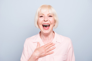 Closeup portrait of old adult caucasian blonde glad cheerful amazed surprised lady smiling, opened...