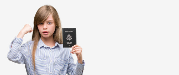 Young blonde toddler holding american passport annoyed and frustrated shouting with anger, crazy and yelling with raised hand, anger concept