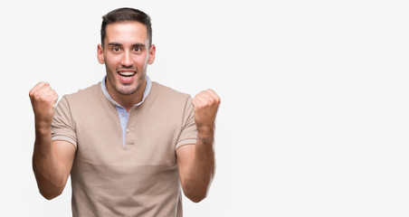 Handsome young man screaming proud and celebrating victory and success very excited, cheering emotion