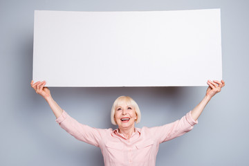 Positive happy old woman hold poster with empty space. Transparency concept with copyspace for text...