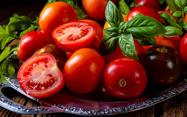 various types of tomatoes served and presented on the silver platter.