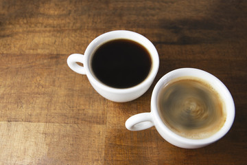 Coffee cups on wooden table background