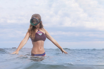 girl on the beach in an underwater mask