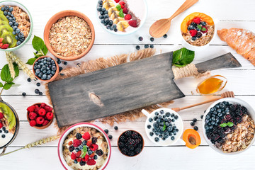 Large Assortment of porridge with fruit and berries. Breakfast. On a white wooden background. Top view. Free space for text.