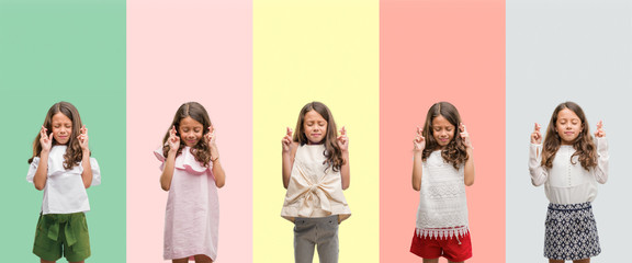 Obraz premium Collage of brunette hispanic girl wearing different outfits smiling crossing fingers with hope and eyes closed. Luck and superstitious concept.