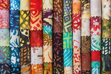 Foto op Plexiglas Stack of colorful quilting batik fabrics as a vibrant background image © MaxCab