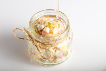 Russian salad in the glass can