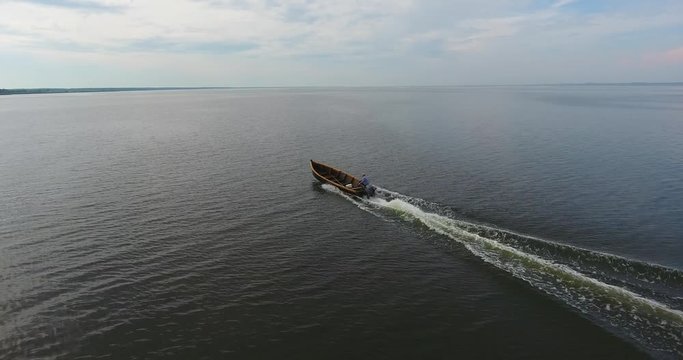 AERIAL. The small fisherman's boat returns from the fishing. Smooth water. No more objects - 7