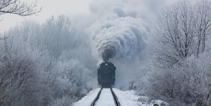 steam locomotive with steam clouds in winter, front view, Slovakia