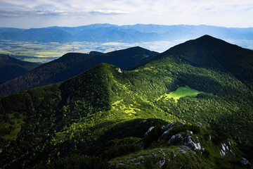 Fototapeta premium view of the valley on a mountain green saddle