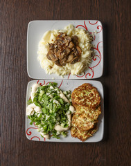 On the table two plates with food. The view from the top.