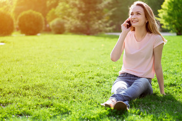 Fototapeta premium girl on the lawn talking on the phone