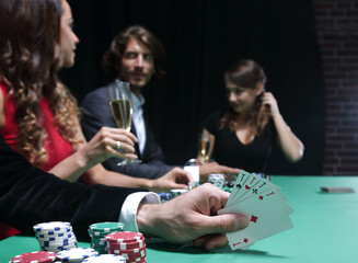 Closeup of poker hand of aces in pastel colors