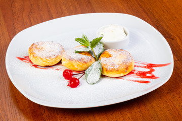 Delicious syrniki with cream