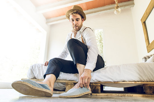 Man Putting His Shoes On At Home.Man Changing Clothes At Home