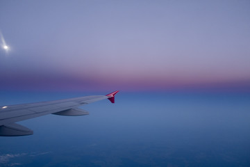 wing of an airplane in a beautiful night sky