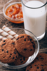 Breakfast with milk and cookies on wooden table