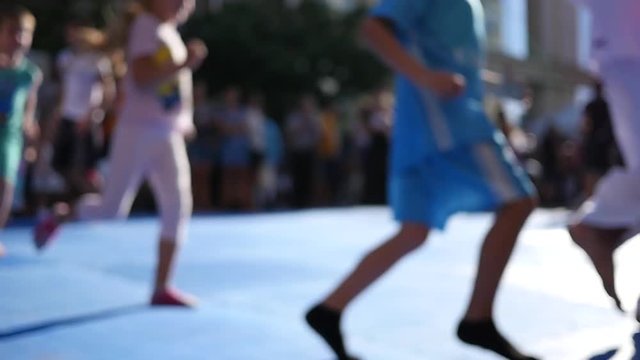 Kids silhouettes running in slow motion at street festival sport workout