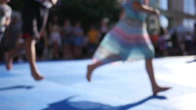 Kids legs running in slow motion at street festival sport workout