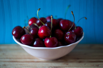 red ripe cherry in a white cup