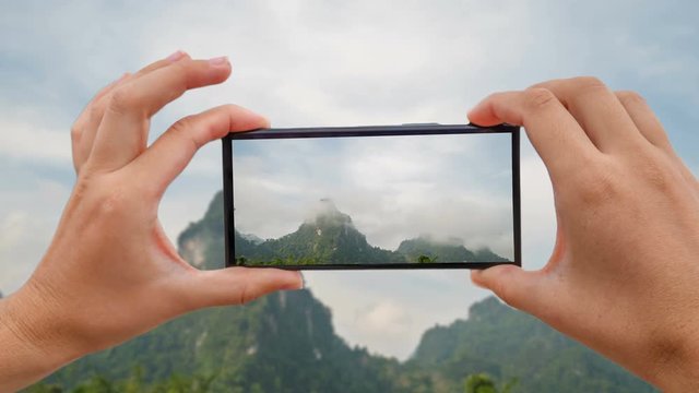 Cinemagraph of Taking Mobile Photo of Limestone Mountain in Cloudy Weather in Khao Sok, Thailand