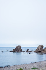 Fototapeta na wymiar Beach with rocks in the background