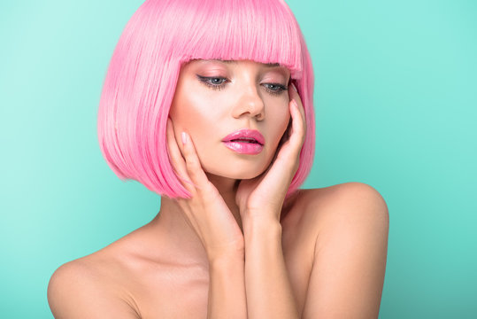 sensual young woman with pink bob cut isolated on turquoise