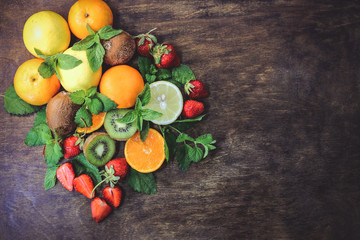 citrus fruits  and strawberries on a wooden background