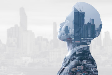 The double exposure image of the businessman thinking during sunrise overlay with cityscape image....