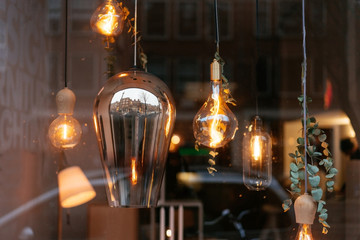 Fototapeta na wymiar Incandescent lamps in room behind the glass