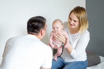 mom and dad playing with baby