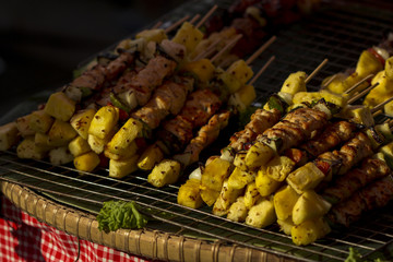 Pork barbecue sticks with tomato, pineapple and bell pepper on banana leaf ,Thailand.